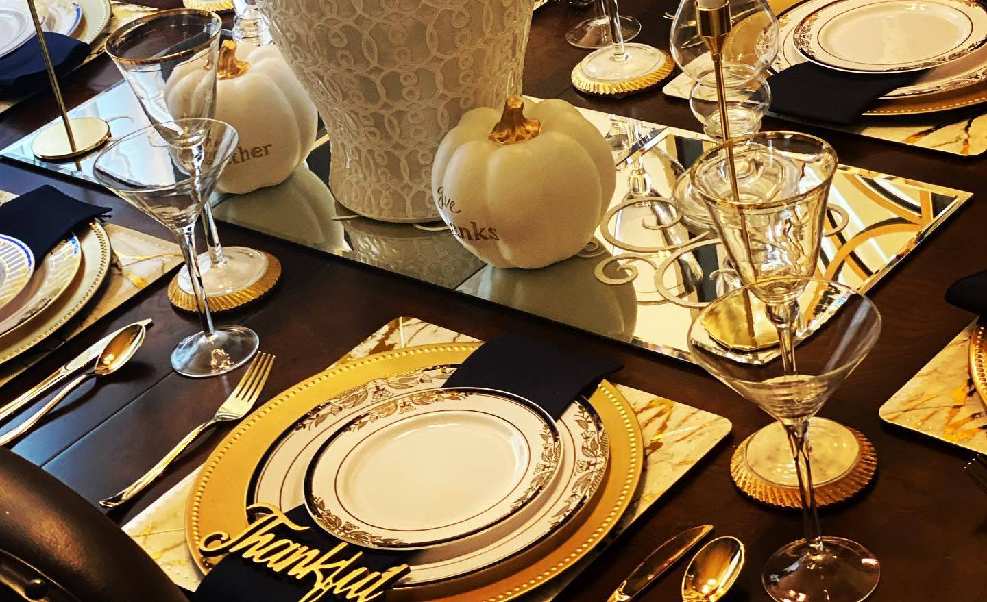 A Thanksgiving table arranged with elegant plastic dinnerware sets.