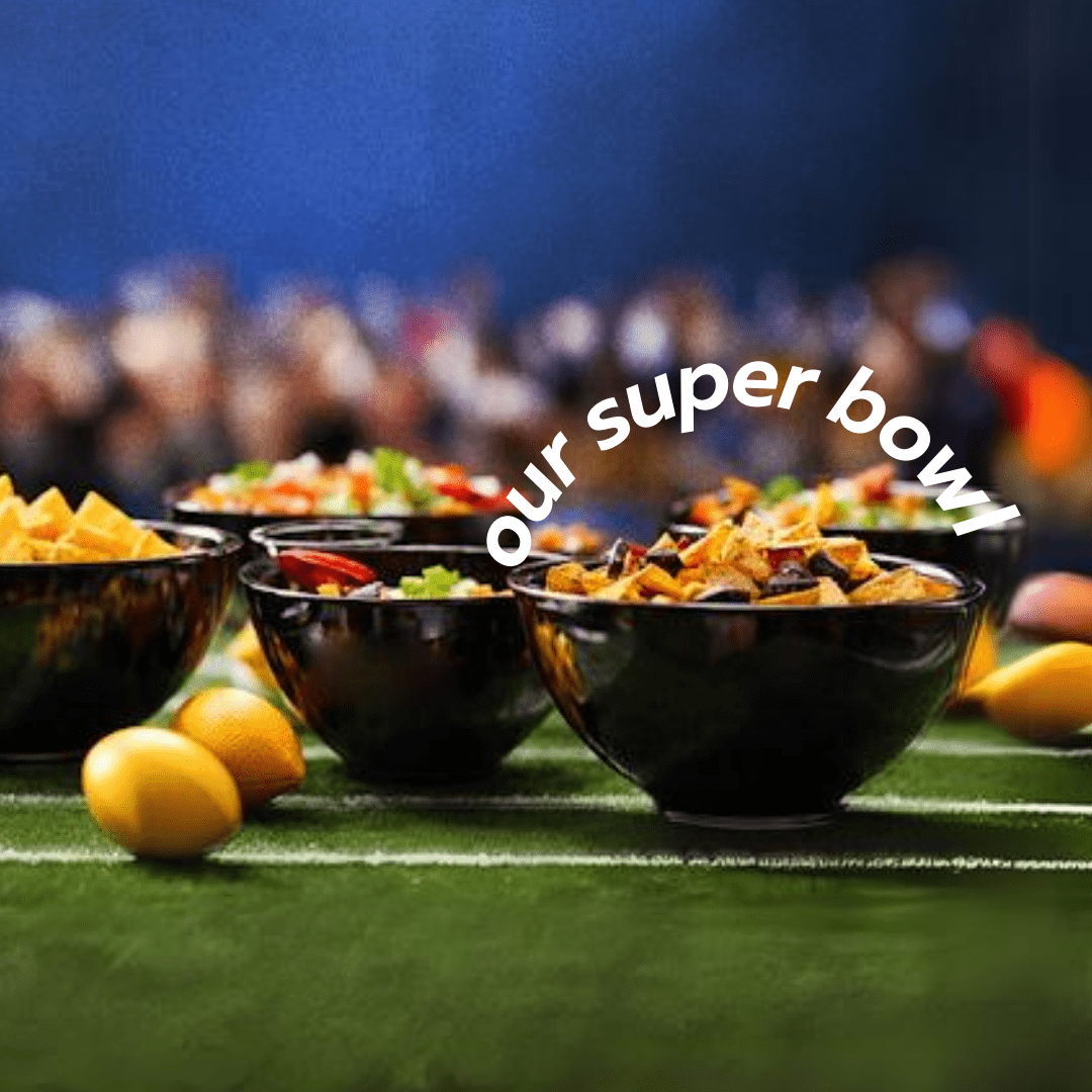 An assortment of chips and snacks in bowls on a football field, set with NFL party disposable dinnerware for a festive gathering.