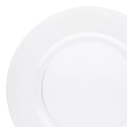 Close-up of a plain white circular plate. The plate has a smooth surface with a subtle gold rim around the edge. The background is also white, highlighting the simplicity and cleanliness of the 13-inch diameter Clear Round Disposable Plastic Charger Plate's design.