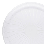 A close-up of a 14" Clear Pavilion Round Disposable Plastic Tray reveals subtle, radiating embossed lines extending from the center to the edges, creating an elegant spoke-like pattern. The plain white background accentuates the design details often seen in high-quality event trays.