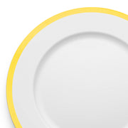 A close-up image of a White with Gold Rim Round Disposable Plastic Charger Plate (13"). The 13-inch diameter plate is empty, and the photo focuses on the upper right section.