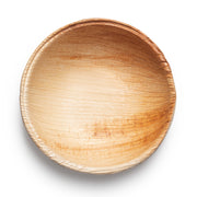 A top-down view of a Round Palm Leaf Eco Friendly Mini Disposable Sauce Bowl (2.5 oz.), showcasing its smooth texture and natural wood grain patterns. The bowl, ideal for eco-friendly party supplies, features a gentle gradient from light brown to beige with slightly darker edges, highlighting various shades of the palm leaf material. The background is plain white.