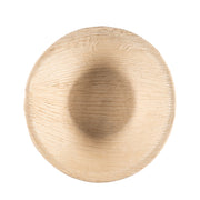 A Round Palm Leaf Eco Friendly Disposable Soup Bowl (8 oz.), viewed from above, showcases the grain and texture of the beige wood, giving it a rustic appearance. The bowl features a smooth, concave center with slightly raised edges, resembling traditional wooden bowls but made from sustainable palm leaves.