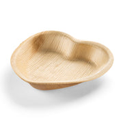 The Heart Natural Palm Leaf Eco-Friendly Disposable Appetizer/Salad Plate is a small, heart-shaped dish crafted from light-colored palm leaf material, featuring a natural wood grain texture and slightly raised edges. This compostable and biodegradable piece is displayed on a white background.