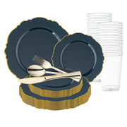 A set of elegant navy plates with gold rims from the Navy with Gold Rim Round Blossom Disposable Plastic Wedding Value Set, neatly stacked. In the center, a set of gold cutlery consisting of a fork, spoon, and knife is arranged. To the right, there's a stack of clear plastic BPA-free cups.