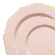 Two overlapping pale pink plates with scalloped edges and thin yellow borders are seen against a white background. The elegant design and pastel colors give these pieces of Kaya Collection's Pink with Gold Rim Round Blossom Disposable Plastic Dinnerware Value Set a delicate and sophisticated appearance, perfect for any occasion.