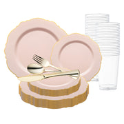 A set of pink and gold plates with scalloped edges, arranged in a stack. Gold-colored cutlery, including a knife, fork, and spoon, is placed on top of the plates. Several clear plastic cups are lined up in the background. The Pink with Gold Rim Round Blossom Disposable Plastic Wedding Value Set by Smarty had a party ensures easy cleanup while looking stunning.
