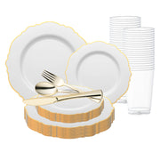 A set of elegant disposable dining ware featuring the "White with Gold Rim Round Blossom Disposable Plastic Wedding Value Set" by Smarty had a party, which includes white plates with gold rims, clear plastic cups neatly stacked in the background, and gold-colored plastic cutlery (forks, spoons, and knives) placed on the plates. Perfect for any occasion, this service for 120 ensures convenience without sacrificing style.