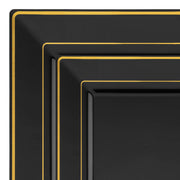 The Black with Gold Square Edge Rim Plastic Dinnerware Value Set includes three nested plates, each painted black with gold trim around the edges. Stacked from largest to smallest, they create a tiered pattern viewed from the top front corner.