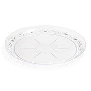 The Kaya Collection Clear Floral Round Disposable Plastic Pastry Plate (6.25") features a starburst and floral etched design along the border, with a subtle starburst pattern radiating from the center. This elegant plate possesses a vintage aesthetic thanks to its intricate floral design.