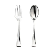 A shiny silver disposable plastic dessert fork with four tines and a matching silver disposable plastic dessert spoon are placed side by side against a white background. Both utensils, part of the "Silver Disposable Plastic Mini Flatware Set - 24 Dessert Spoons and 24 Dessert Forks," have a simple, modern design with smooth, slightly curved handles.