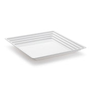 The Kaya Collection 12" x 12" White Square with Groove Rim Plastic Serving Trays feature a minimalistic and modern design, perfect for serving or displaying food. Their slightly raised, ridged edges offer a sleek aesthetic ideal for any occasion. The clean lines of these trays stand out beautifully against a white background, making them an excellent choice as disposable trays for any event.