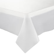 A close-up of a corner of a white tablecloth draped over a rectangular table. The tablecloth appears smooth and neatly arranged, with one corner hanging down naturally. For convenience at any gathering, this could be effortlessly swapped for Clear Rectangular Disposable Plastic Tablecloths (54" x 108"). The entirely white background emphasizes the elegance of the tablecloth.