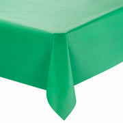 A neatly draped Hunter Green Rectangular Disposable Plastic Tablecloth (54" x 108") covers a rectangular table. The corner of the table is visible, showing the tablecloth hanging down with smooth, crisp edges. The background is plain and white, making these stylish party tablecloths pop with elegance.