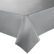 Close-up image of a neatly made bed with a fitted sheet resembling the smooth and slightly reflective texture of Silver Rectangular Disposable Plastic Tablecloths (54" x 108"). The corner of the bedframe is visible, showing the sheet tightly wrapped around the mattress, giving it an elegant and polished look similar to party tablecloths.