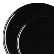 Two black flat round plates from our Black Flat Round Disposable Plastic Dinnerware Value Set are arranged with one overlapping the other, creating a visually appealing composition. The glossy, smooth surfaces of these plates highlight their sleek design, adding an elegant touch to parties while being part of our disposable dinnerware collection.