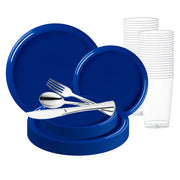 The Solid Blue Flat Round Disposable Plastic Wedding Value Set includes a collection of blue disposable plates in various sizes, paired with clear plastic cups. Silver-colored plastic utensils—fork, spoon, and knife—are elegantly arranged on top of the plates.