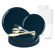 A set of dark blue BPA-free plastic plates in various sizes, stacked alongside a group of clear plastic cups in the background. In the forefront, a golden disposable plastic fork, knife, and spoon are elegantly crossed and placed on top of the plates. This Navy Flat Round Disposable Plastic Wedding Value Set offers service for 120.