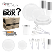 An assortment of party supplies spread out, including the Clear with Silver Vintage Disposable Plastic Tableware Set featuring clear plastic plates, cups, forks, knives, and spoons. Salad plates and soup spoons accompany the set. A cardboard box labeled "Smarty had a Party!" is displayed with the text "What's in the box?" and a "Free Shipping" icon.