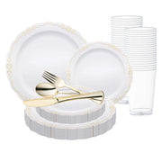 A beautifully organized set of Smarty had a party's White with Gold Vintage Rim Round Disposable Plastic Wedding Value Set, featuring white plates with elegant gold decorative edges, complemented by clear plastic cups and golden disposable flatware—including a spoon, fork, and knife. This arrangement indicates a ready-to-use setup for a formal event or party.