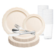 The Ivory Vintage Round Disposable Plastic Wedding Value Set from Smarty had a party features a collection of beige plastic tableware, including large and small plates with ornate borders, stacked neatly. In the center, there's a bundle of BPA-free silver-colored plastic cutlery consisting of forks, spoons, and knives. Clear plastic cups are stacked in the background, making it the perfect disposable dinnerware for service for 120.