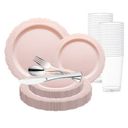 The Pink Vintage Round Disposable Plastic Wedding Value Set by Smarty had a party features a set of elegant, light pink disposable party supplies, including ornate-edged plates in various sizes, clear plastic cups arranged in a stack, and a set of silver plastic cutlery (fork, spoon, and knife) placed on top of the plates. This perfect plastic tableware is ideal for any celebration.