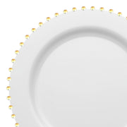 Introducing our White with Gold Pearl String Round Disposable Plastic Salad Plates (7”), these plates showcase a smooth, white surface complemented by a circular ridge near the edge. The rim is adorned with a charming pattern of small, evenly-spaced yellowish-gold dots, reminiscent of an elegant gold pearl string. Combining simplicity and sophistication, they are perfect for refined dining occasions.