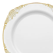 The White with Gold Fancy Round Disposable Plastic Dinner Plates (10.25”) feature a sophisticated white design with an ornate gold trim along the rim. These plates boast intricate and elegant patterns, adding a touch of refinement to any setting. They are sturdy and break-resistant, making them ideal for weddings, parties, and events. Displayed against a plain white background.