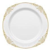 The White with Gold Fancy Round Disposable Plastic Dinner Plates (10.25”) feature a white design with an intricate gold decorative border along the rim. The center of the plate is plain and glossy, providing an elegant and sophisticated appearance, ideal for weddings, parties, or events.