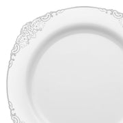 Product Name: White with Silver Fancy Round Disposable Plastic Salad Plates (7.5”)

An elegant disposable plate featuring a clean, white surface and sophisticated silver designs around the edge. Perfect for upscale table settings, its classic design offers a timelessly refined appearance. The center of the 7.5-inch plastic salad plate remains plain and smooth for added simplicity.