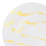 A close-up image shows two overlapping plates from the White with Gold Marble Stroke Round Disposable Plastic Dinnerware Value Set. The design features gold streaks that have an abstract, irregular quality, giving the disposable dinnerware an elegant and sophisticated appearance.