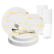 A White with Gold Marble Stroke Round Disposable Plastic Wedding Value Set, featuring a stack of white disposable plates with gold marbling, elegantly paired with matching white napkins and a gold plastic dinnerware set that includes forks, knives, and spoons. Clear disposable plastic cups are neatly arranged in the background. Perfect for elegant occasions like weddings.