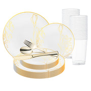 The White with Gold Antique Floral Round Disposable Plastic Wedding Value Set by Smarty had a party features an elegant set of white plates adorned with gold floral patterns, complemented by gold utensils (knife, fork, and spoon). Behind the plates, you can see a stack of BPA-free polystyrene clear plastic cups. This disposable wedding dinnerware adds a touch of sophistication to any celebration.