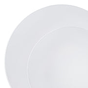 Close-up of two elegant White with Silver Rim Organic Round Disposable Plastic Dinnerware plates from Kaya Collection, stacked slightly off-center against a plain white background, showing the rim of the top plate overlapping a small portion of the bottom one.