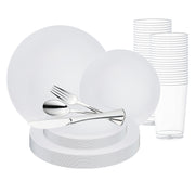 The "White with Silver Rim Organic Round Disposable Plastic Wedding Value Set" from Smarty had a party includes stacks of large and small plates, clear plastic cups, and shiny plastic silverware consisting of knives, forks, and spoons. This elegant service for 120 is arranged neatly against a white background.