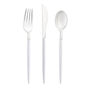 The Silver with White Handle Moderno Disposable Plastic Cutlery Set is displayed, featuring a fork, knife, and spoon. Each piece boasts a sleek, metallic head and a slender white handle. The utensils are arranged neatly with the fork on the left, the knife in the center, and the spoon on the right. These stylish pieces are BPA-free disposable plastic cutlery items.