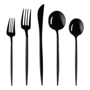 A set of five stylish, contemporary black cutlery items from the Kaya Collection: a salad fork, a dinner fork, a knife, a soup spoon, and a teaspoon, all aligned vertically side by side against a white background.