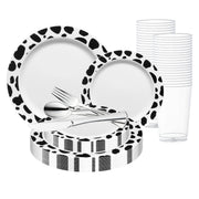 The White with Black Dalmatian Spots Round Disposable Plastic Wedding Value Set features a beautifully arranged meal setting for 120 guests, complete with spotted plates, striped napkins, clear plastic cups, and silver-colored plastic cutlery (fork, knife, and spoon).