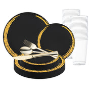 Introducing the Black with Gold Moonlight Round Disposable Plastic Wedding Value Set: an elegant ensemble featuring black plates with golden rims, available in both large and small sizes. This set includes gold-colored plastic cutlery (fork, knife, and spoon) arranged at the center, along with stacked clear plastic cups for a complete service for 20.