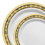 Two plates from the Kaya Collection's "White with Black and Gold Royal Rim Plastic Dinnerware Value Set" are shown, one partially overlapping the other. Both plates feature intricate gold and black decorative patterns along their rims, with elegant swirls and floral designs. The overall style is ornate and luxurious, perfect for a wedding reception that spares no detail.