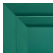 Close-up image of a hunter green square plate from the Kaya Collection. The Hunter Green Square Plastic Plates Dinnerware Value Set features a plain design with a smooth surface and slightly raised edges, making it part of a stylish dinnerware set.