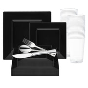 The Black Square Plastic Wedding Value Set by Smarty had a party features black square plates in both small and large sizes, with stainless steel cutlery (knife, fork, and spoon) neatly placed on top. To the right, a stack of clear plastic cups completes the arrangement. This disposable dinnerware set is meticulously displayed against a white background.