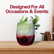 A refreshing beverage with a mint garnish and a slice of lime, served in Kaya Collection's 12 oz. Clear Elegant Stemless Plastic Wine Glasses filled with ice, is placed on a wooden surface. The background is blurred with greenery and a text overlay above the drink reads "Designed For All Occasions & Events" in red.