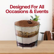 A glass filled with layers of dessert, including cream, cake, and cocoa powder, is placed on a wooden surface. The background is slightly blurred with indoor decor elements. The text above reads "Designed For All Occasions & Events" in bold red letters. Try our 5.5 oz. Clear Octagon Disposable Plastic Dessert Cups for added elegance!