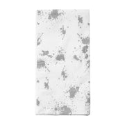 The White with Silver Paint Splatter Paper Dinner Napkins, featuring a folded design with silver paint splatter patterns resembling abstract paint splashes scattered across the white surface, are perfect for a special occasion.