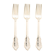 Three Shiny Baroque Gold Plastic Forks with decorative handles are aligned in a straight row against a white background. The forks have an intricate design on their handles, featuring scrollwork and floral patterns, giving them a vintage appearance, ideal for any luxurious event.