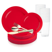 The Solid Red Holiday Round Disposable Plastic Wedding Value Set features a collection of vibrant red plastic plates in both large and small sizes, along with gold-colored cutlery including forks, spoons, and knives. Complementing the set are clear plastic cups neatly stacked beside the plates. This comprehensive disposable dinnerware set, serving 20, is elegantly arranged against a white background.